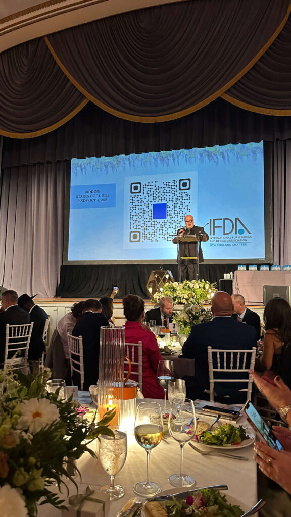 IFDA New England Awards Boston Chapter President John Trifone of Minotti speaks to the audience during the 2025 ceremony