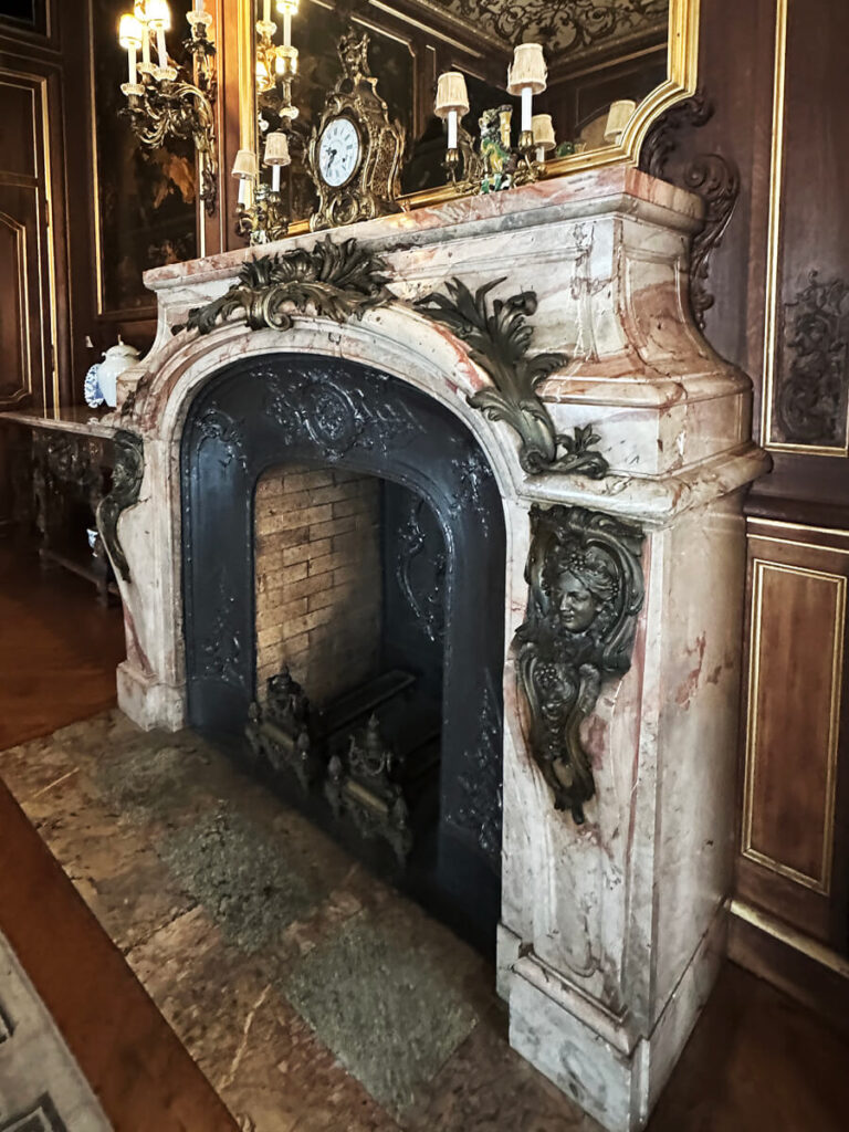 Historic fireplace at The Elms in Newport admired by interior decorators in Boston for its carved marble and ornate detailing.