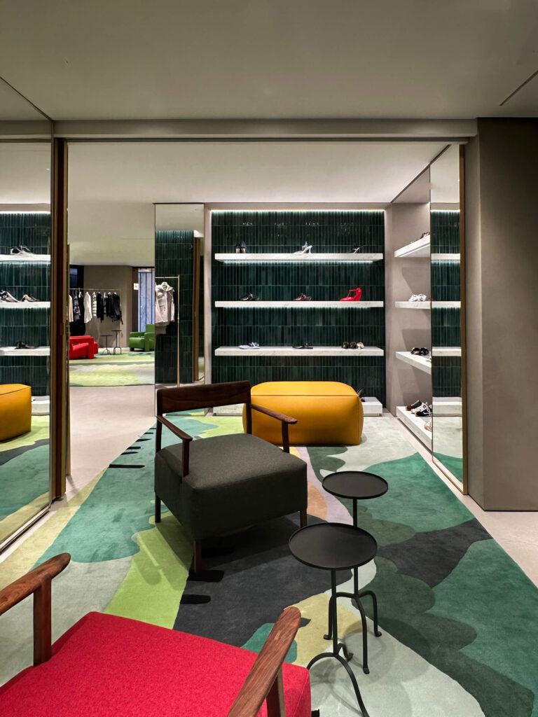 Loewe boutique interior at Harrods London featuring a red chair and plaster walls—modern luxury from Eat Sleep Shop London.