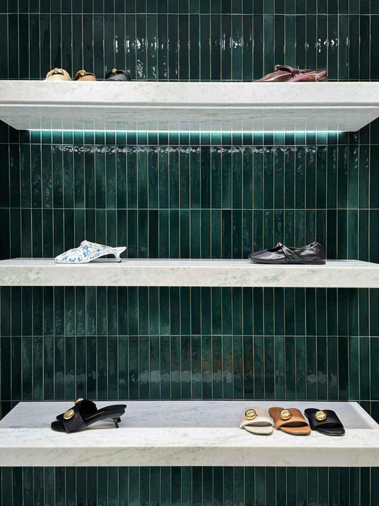 Loewe luxury brand retail space at Harrods London featuring glossy green tile and minimalist design.
