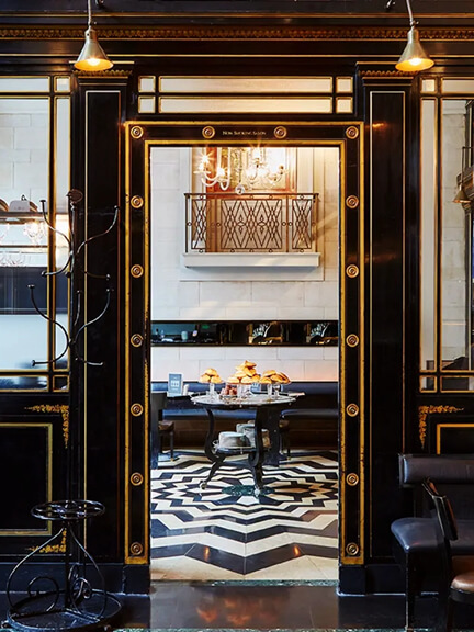 Eat sleep shop London highlights The Wolseley with black and white marble tiles, gilded screens, and classic lighting in a landmark dining room.