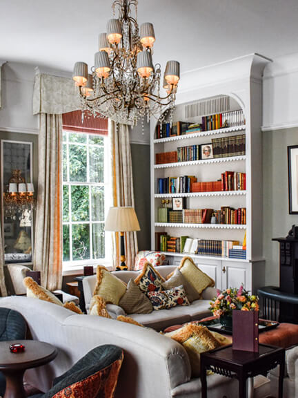 London restaurant design at No 50 Cheyne highlights a traditional tea room with custom upholstery, classic bookcases, and refined British interiors.