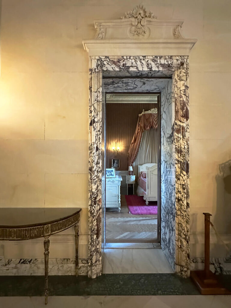 Marble door trim with antique furniture at The Elms in Newport, Rhode Island, a refined example of Gilded Age Interior Design.
