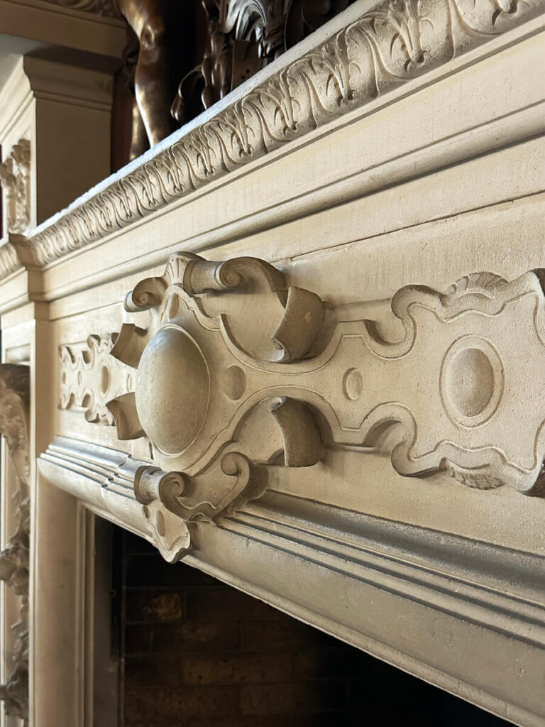 Fireplace at The Elms in Newport, a refined example of Gilded Age Interior Design showcasing marble and carved detailing.