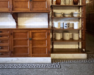 Gilded Age interior design at The Elms kitchen with marble floors, tiled walls, and classic craftsmanship inspiring modern homes.