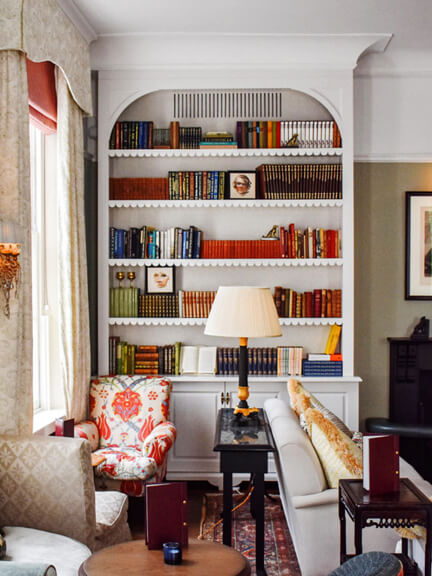 London restaurant design at No 50 Cheyne features traditional interiors with bookcases and custom upholstered furniture in the tea room.