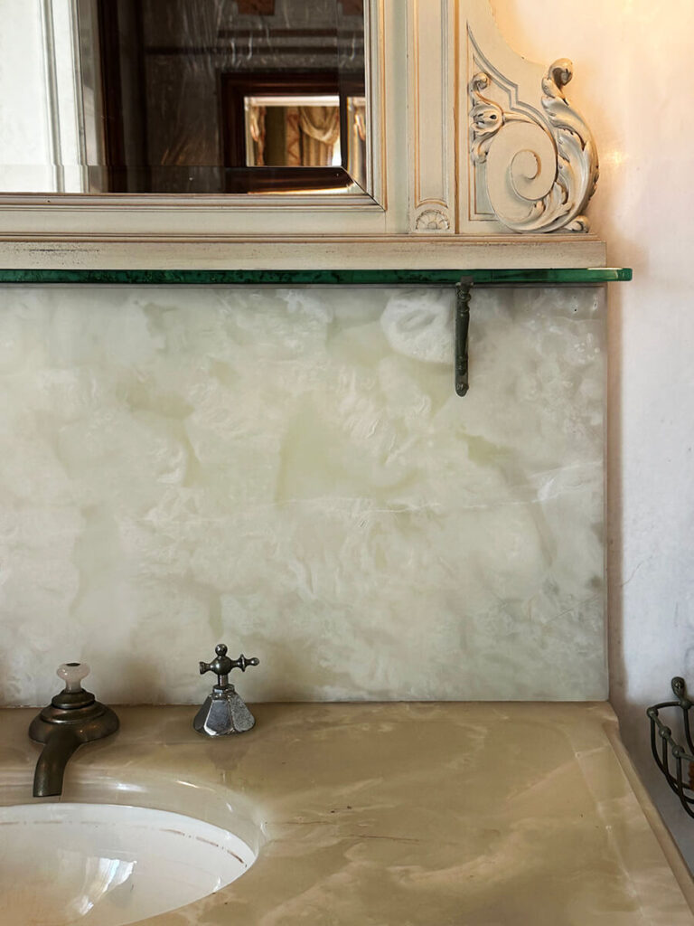 Onyx backsplash in the historic bathroom at The Elms in Newport, Rhode Island, highlighting refined materials and craftsmanship.