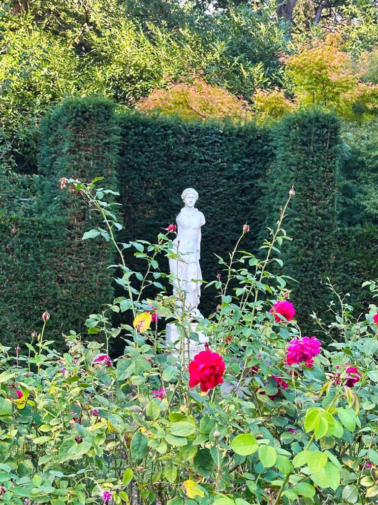 Historic English Estate Design highlighted by Russian sage flowers blooming in the gardens at Cliveden House in Buckinghamshire.