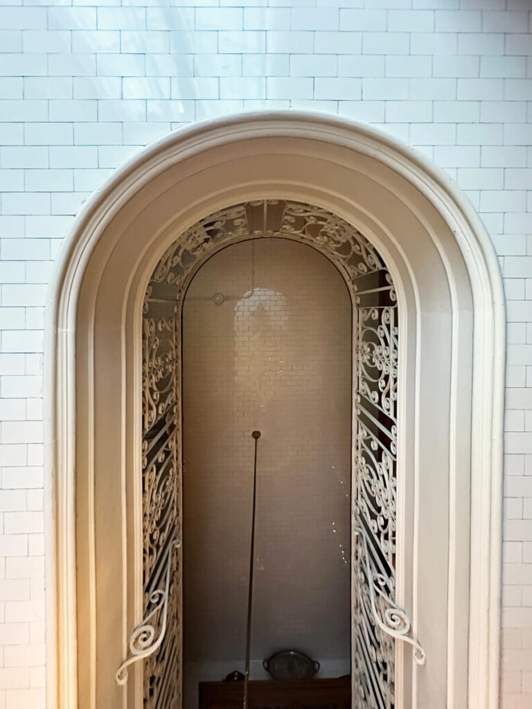 Two-story kitchen at The Elms in Newport, Rhode Island, with a tiled ceiling and custom cabinetry showcasing historic craftsmanship.