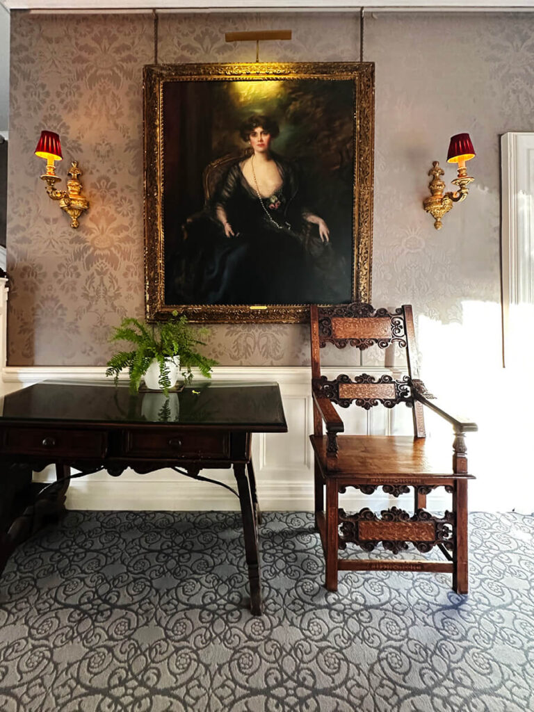 Vintage furniture and art arranged in an English manor, showcasing craftsmanship and texture in British interior design.