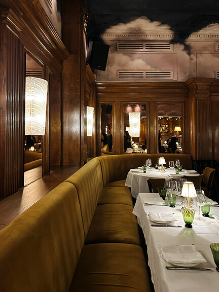 Custom upholstery and painted ceiling at Tramp in London showcase bold private club interior design.