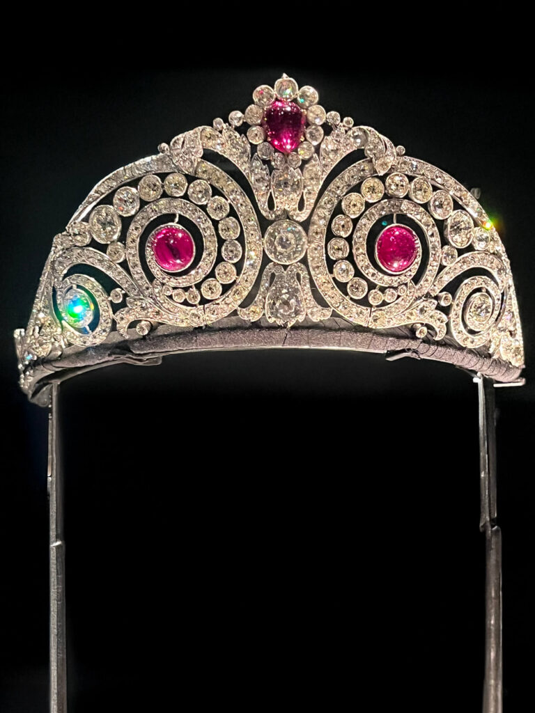 A Cartier tiara featuring rubies and diamonds arranged in a refined, balanced design.