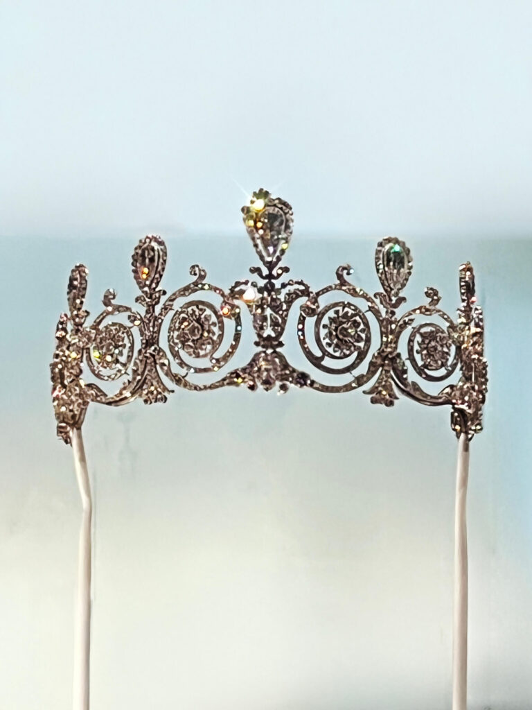 A Cartier platinum garland-style tiara from 1905 featuring delicate ribbon and wreath motifs in the Cartier Jewelry Exhibit.