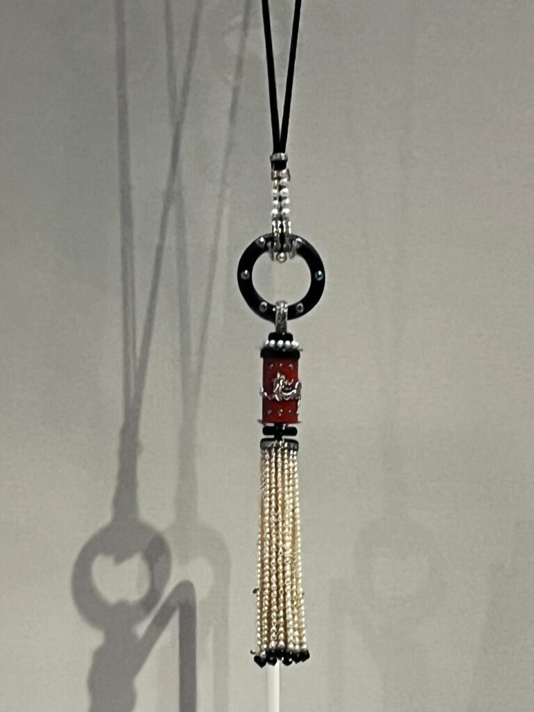 Grace Curzon’s Cartier necklace with pearls, coral, emeralds, and diamonds displayed in the Cartier Jewelry Exhibit.