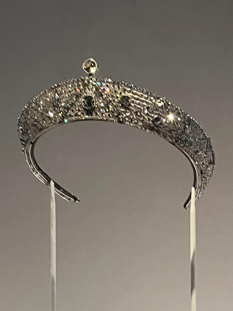 An Oriental-style Cartier bandeau tiara from 1911 with geometric openwork and diamonds.