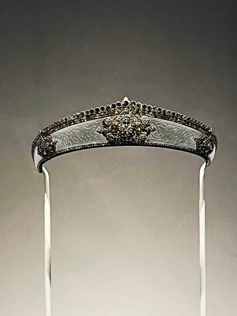 A 1912 Cartier special-order tiara with intricate platinum work and elegant diamond detailing.