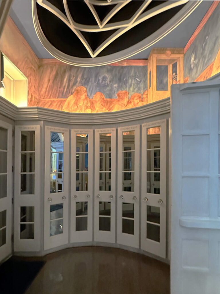 The Cosmic House London entry with custom closets, mirrored doors, oval and geometric ceiling shapes and unique built-ins