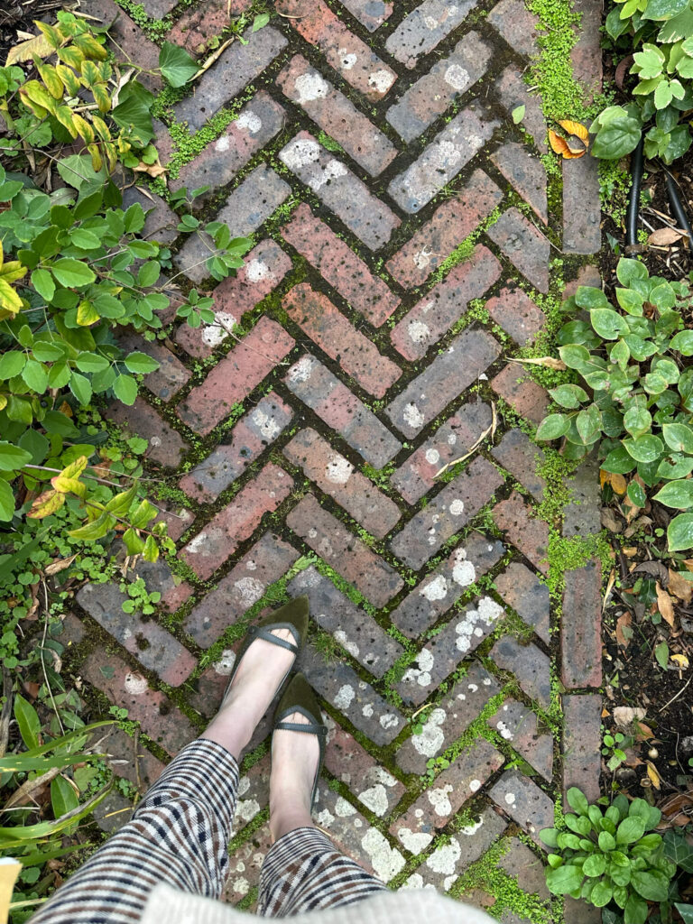 Garden herringbone brick pavers and stonework in a landscaped London space in Holland Park showing classic architectural details