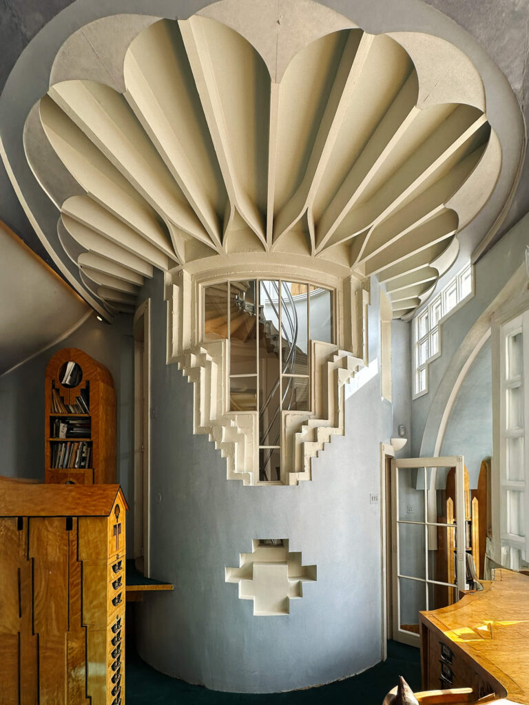 Geometric stair and ceiling design at the Cosmic House in Holland Park London with light blue plaster and off-white shapes