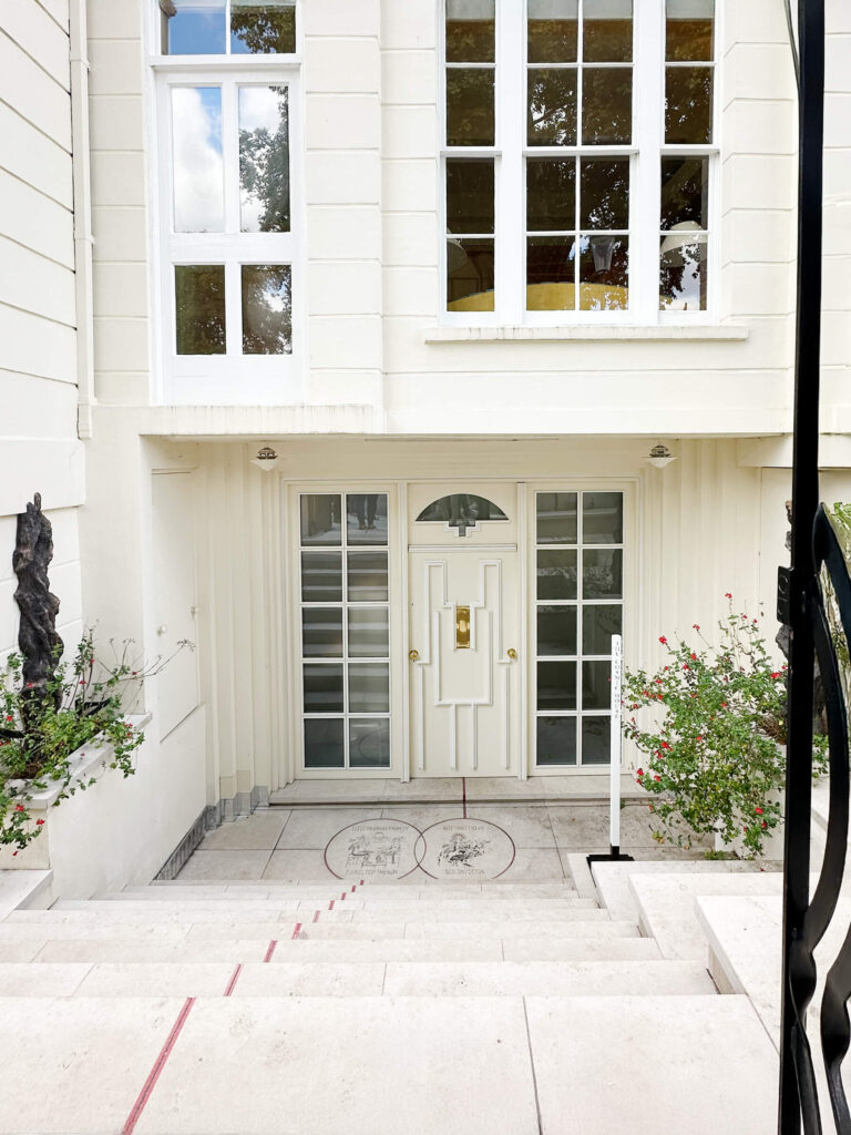Classic white exterior in Holland Park with a unique geometric patterned door