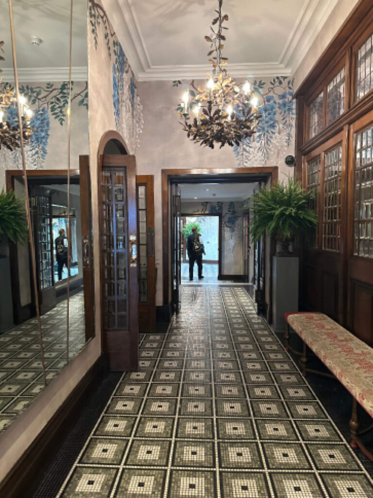 Mosaic tile flooring Brown’s Hotel London classic interior design at a London hotel and restaurant where to eat London, shown in patterned stone underfoot.