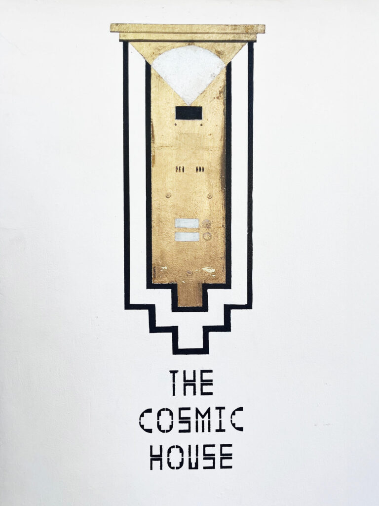 Brass and painted graphic doorbell at the entry, combining postmodern architecture elements in Holland Park