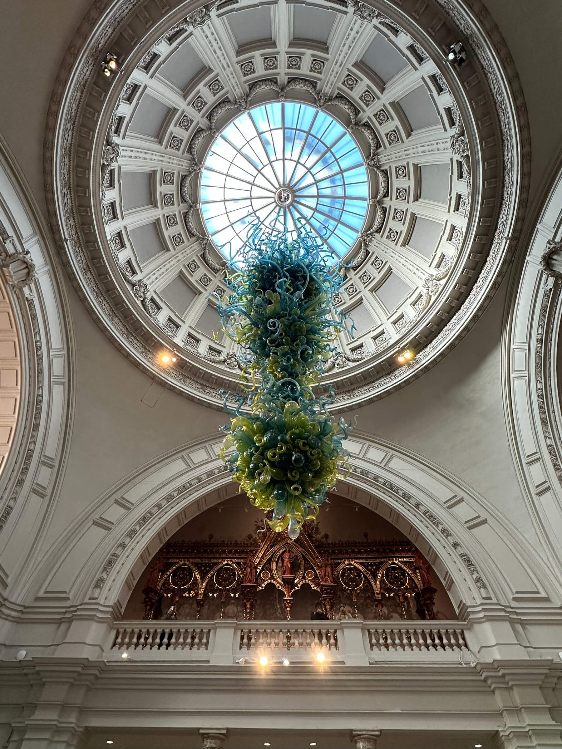 Victorian tile patterns set the tone beneath the dome in the foyer entry at the Victoria and Albert Museum, historic London architecture.