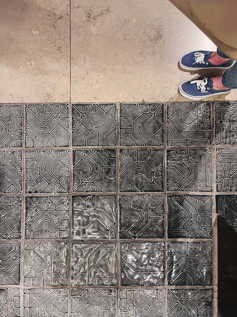 Textured floor tile and limestone flooring appear together inside the Victoria and Albert Museum in London, showing another example of the building’s varied surfaces.