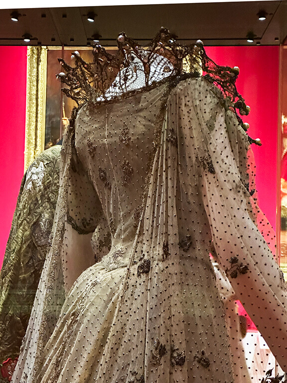 Kensington Palace Interiors featuring a coronation dress displayed in the King’s Gallery during the Edwardian Age exhibit.