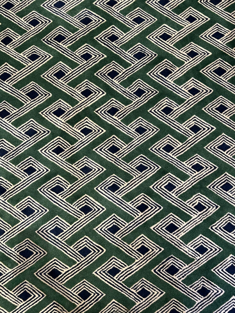 Custom green and black geometric carpet designed for a luxury retail interior