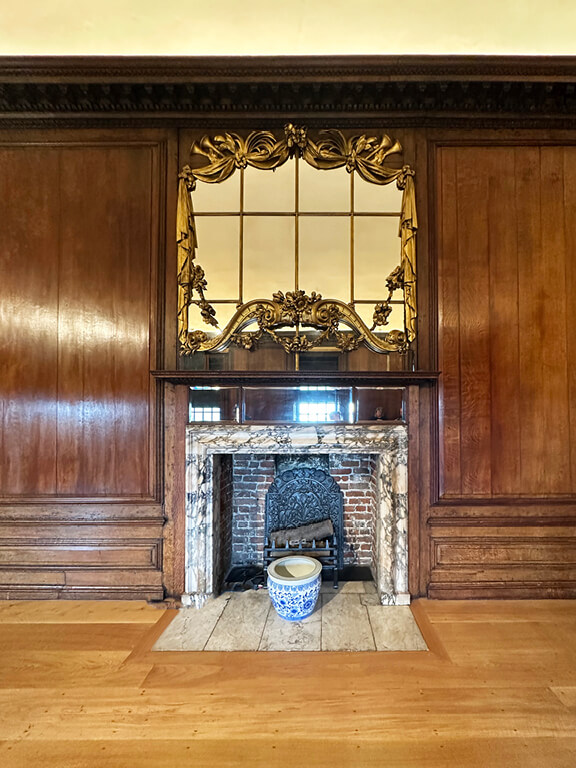 Queen’s State Apartment featuring wood paneling and a marble fireplace inside Kensington Palace.