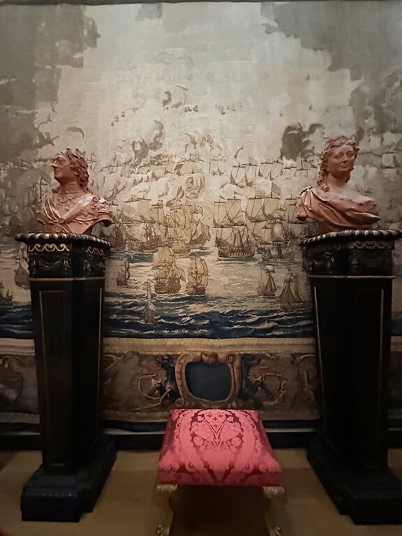 Kensington Palace Interiors featuring a vintage tapestry displayed with antiques in a historic London room.