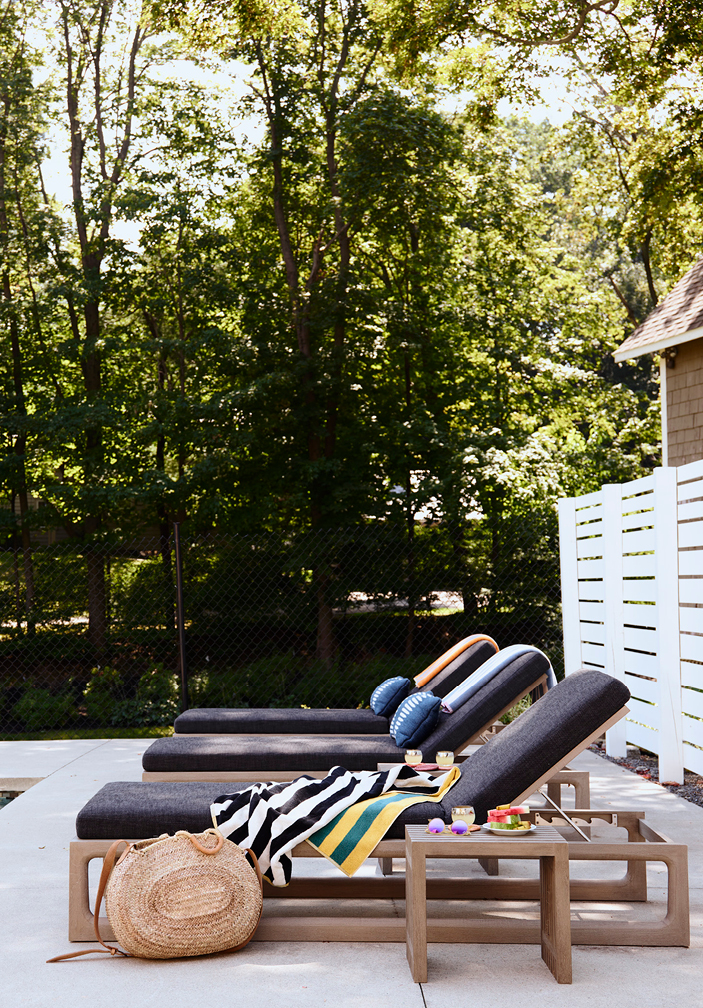 Poolside patio at a historic Hingham home featuring a trio of chaise lounge chairs, creating a relaxing outdoor space. Showcasing New England interior design by Boston Interior Designer Sarah Scales.