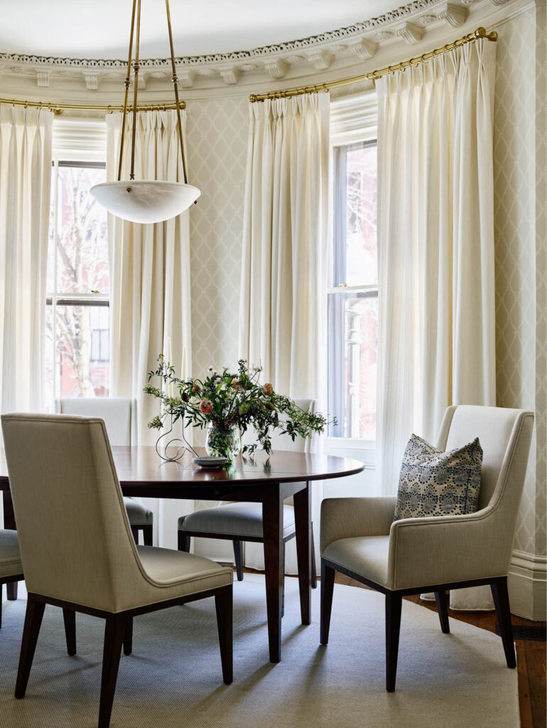 Formal dining room in a historic brownstone renovation with a classic alabaster pendant, designed by Boston interior designer Sarah Scales.