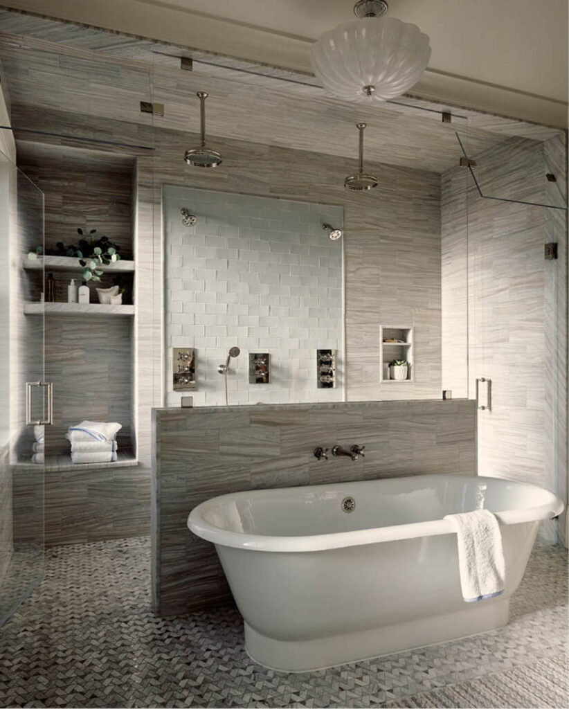 The primary bathroom features a walk-in shower with dual heads, a freestanding tub, soft grey marble, mosaic flooring, and custom ceramic tile.