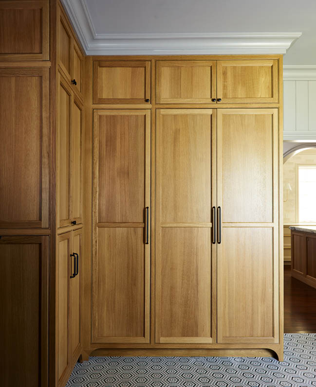 Milton home renovation by Sarah Scales Design Studio, showcasing custom natural oak pantry units, geometric mosaic floor tiles, oil-rubbed bronze hardware, and light grey trim and ceiling.