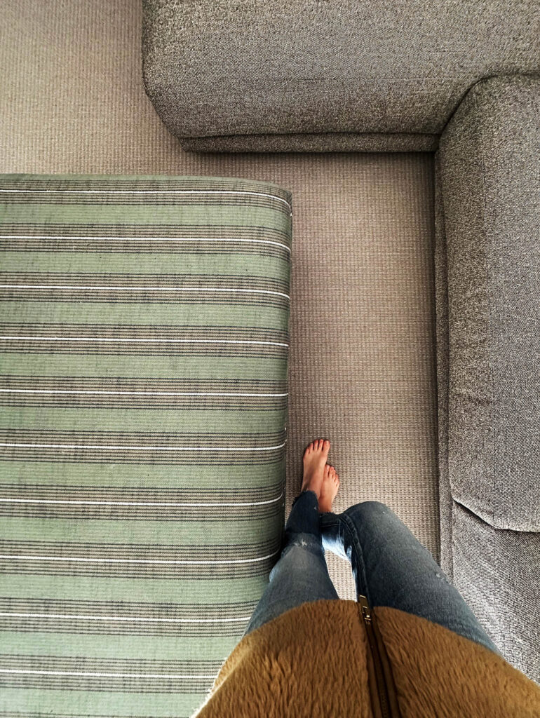 Looking down at the custom green striped ottoman and Blu Dot sectional in the Vermont mountain home.