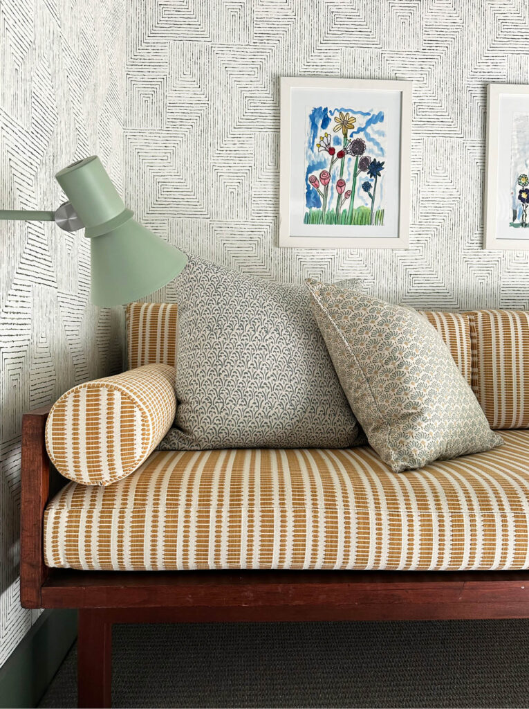 Reupholstered vintage daybed in yellow and cream Zak and Fox fabric with Kravet wallpaper and light green sconces in the Vermont mountain home.