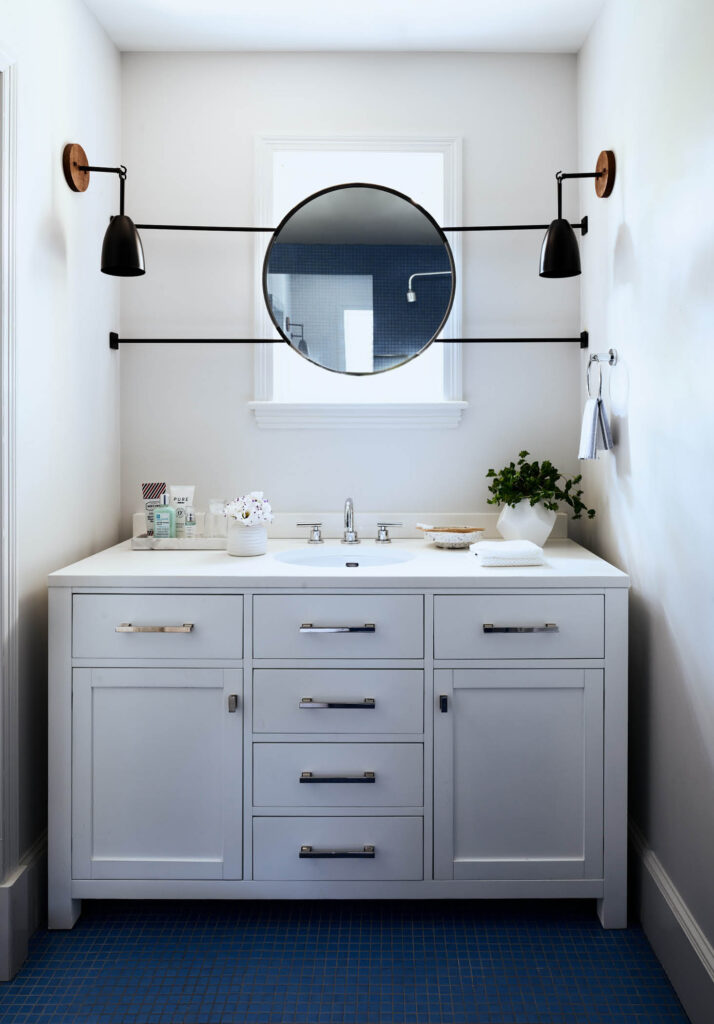 HIngham kids bathroom design with bold blue mosaic tile flooring and simple white vanity, by Boston interior designer Sarah Scales.