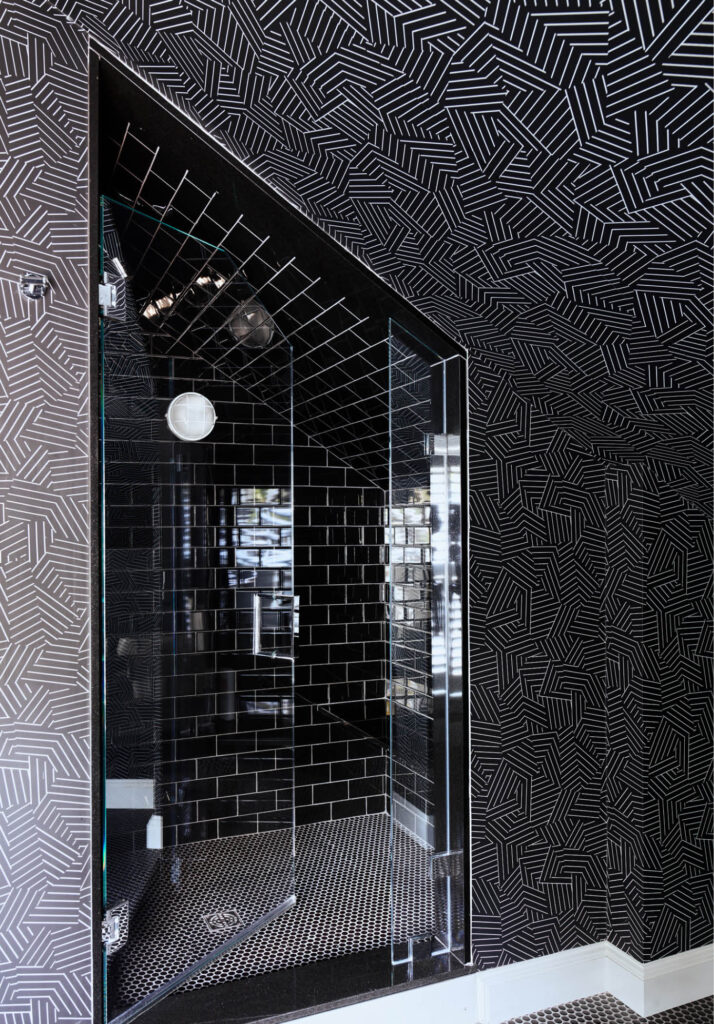 Hingham kids bathroom design featuring black subway tile, black penny floor tile, and black geometric Kelly Wearstler wallpaper. Designed by Boston interior designer Sarah Scales.