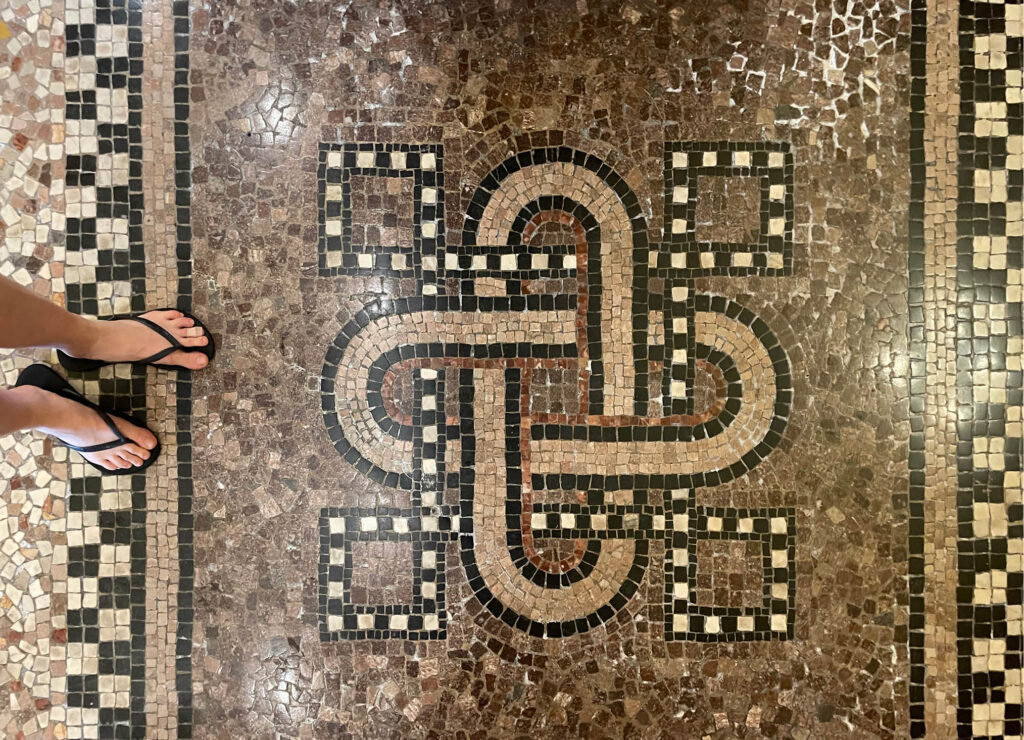 Mosaic stone floor tiles inside the main building of Flagler College, arranged in a unique Celtic pattern with both natural and polished stones.