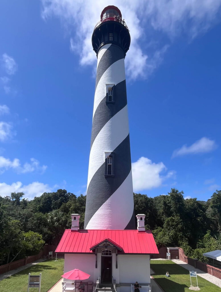 The historic St. Augustine Lighthouse standing tall against a bright sky.