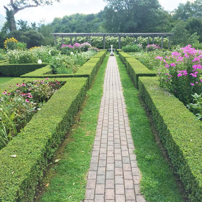 A classic English garden at a historic Vermont estate, showcasing Boston Interior Design Inspiration with timeless New England landscaping.