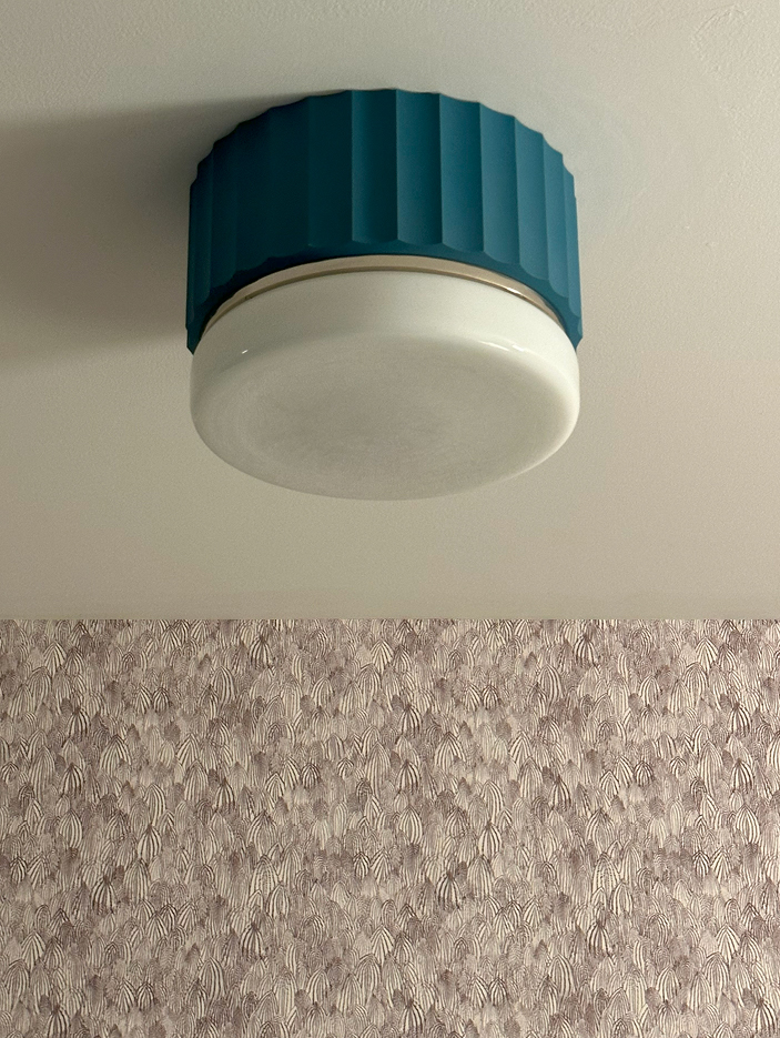 Custom aqua Urban Electric Hudson light fixture paired with Schumacher wallpaper, showcasing modern apartment design by a Boston interior designer.