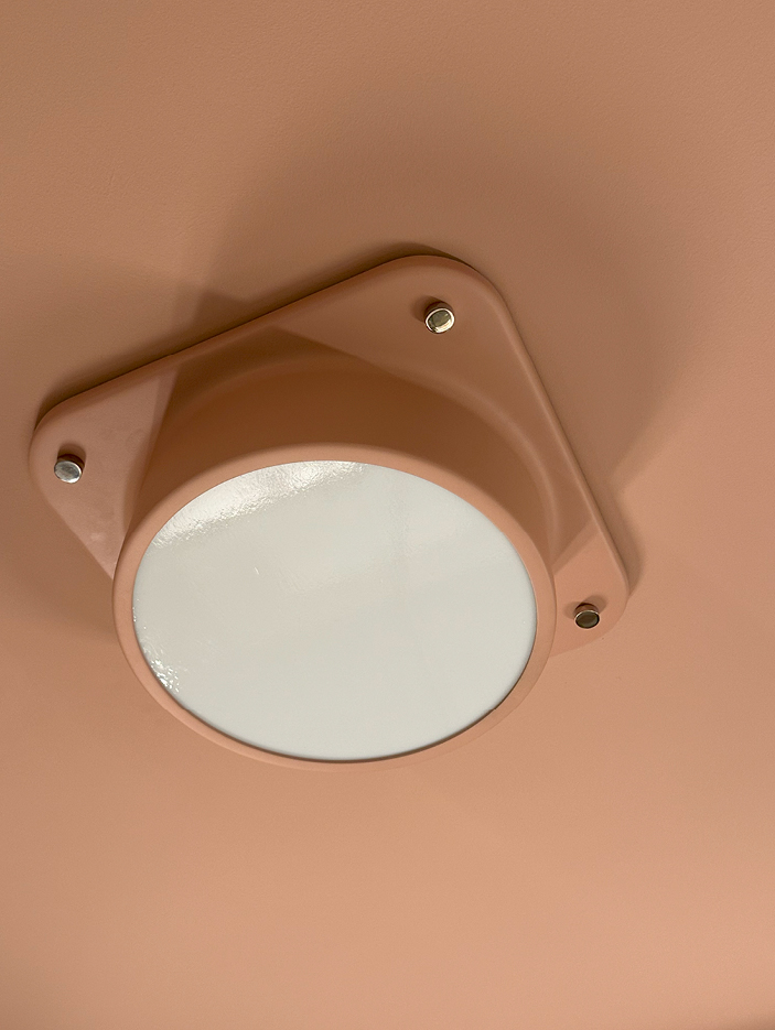 Custom Urban Electric Porte light fixture in the primary bathroom of an Upper East Side apartment, showcasing NYC interior design by Sarah Scales.