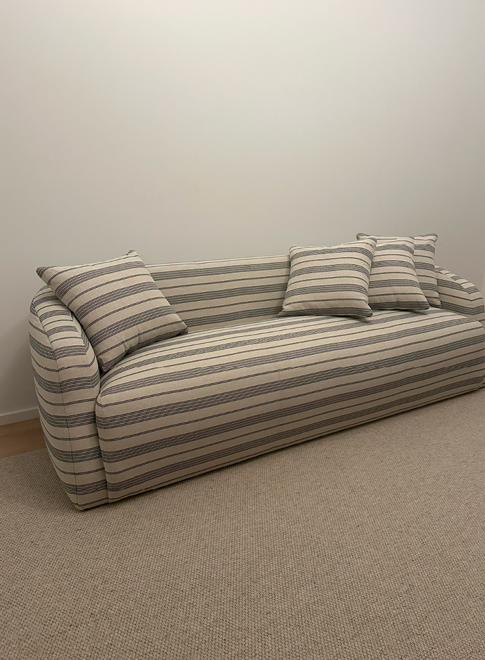 Custom Verellen sofa in striped C&C Milano fabric for the living room of a modern Upper East Side apartment, showcasing NYC interior design.