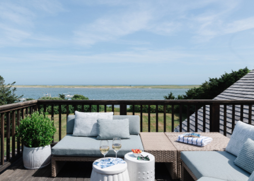 Roof deck at an Edgartown Bay Road home with waterfront views, blending classic architecture and modern furniture by a Boston interior designer.