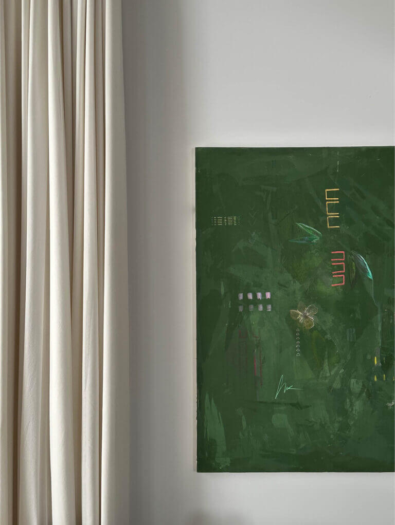 A custom fine art painting by Ali Beletic with a dark green canvas, white walls, and soft white linen drapery in a Vermont home by a Boston interior designer.