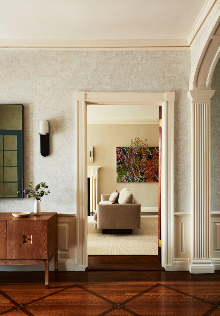 Foyer with classic architectural details and modern furniture at a Concord home, designed by a top Boston interior designer.