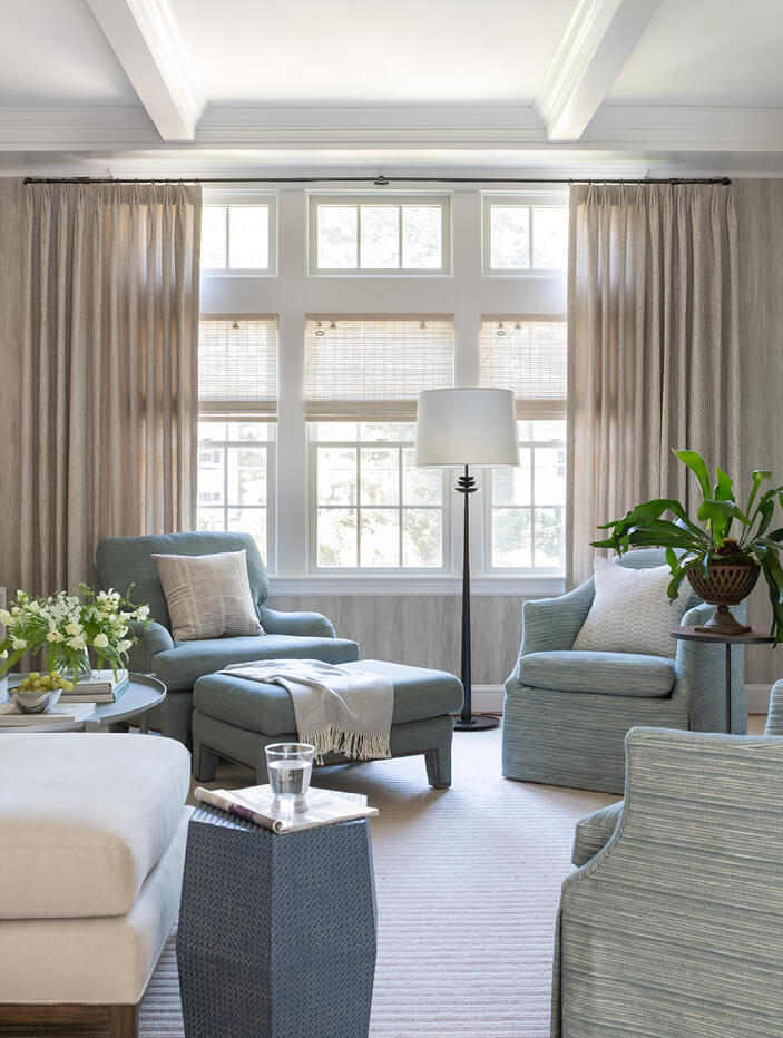 Coastal interior design in a Hingham home with blue and neutral furniture, a coffered ceiling, and classic architectural details.